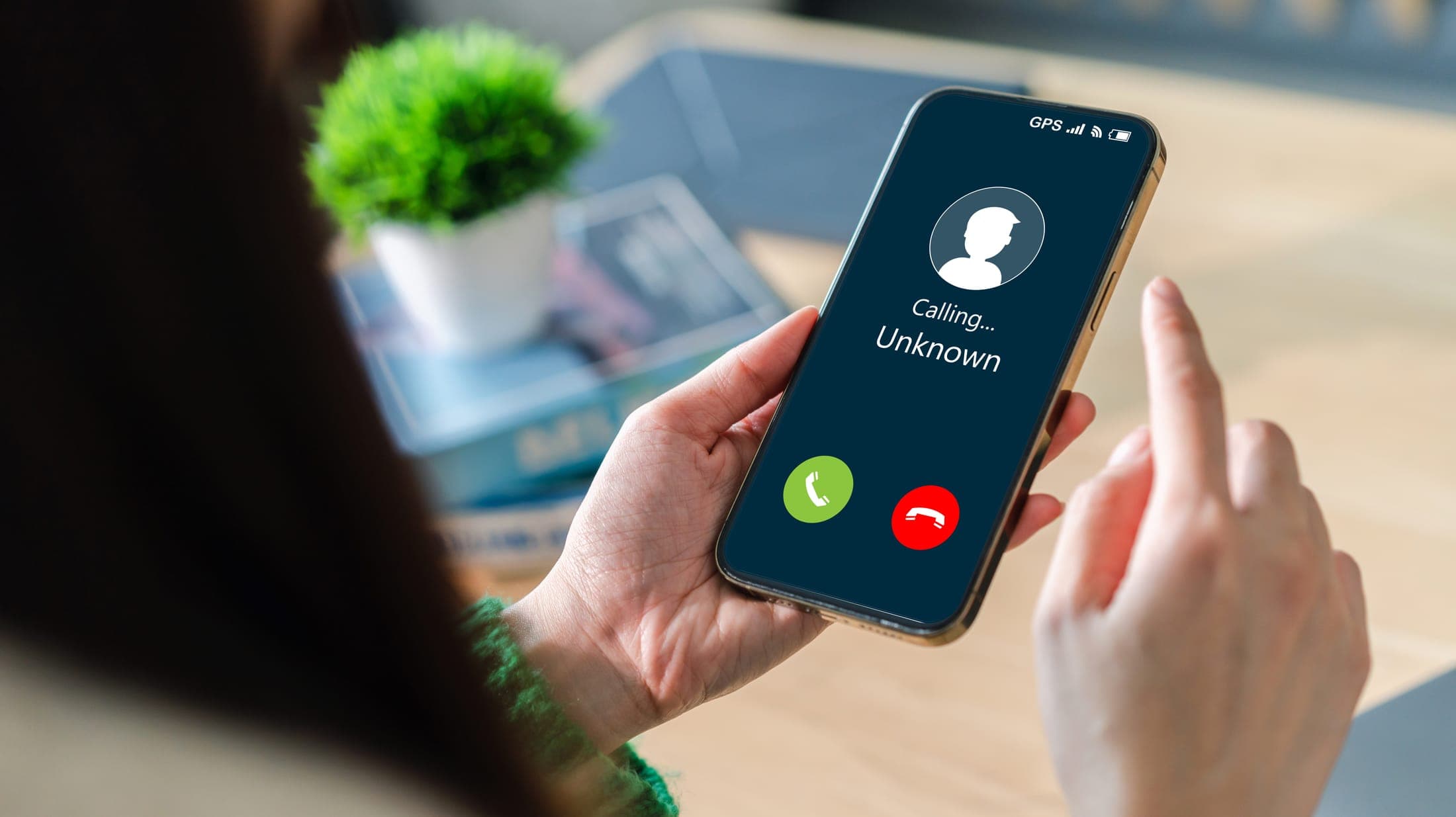 A phone screen showing an incoming call from an unknown number, illustrating the unsolicited calls families receive from commission-driven referral services.